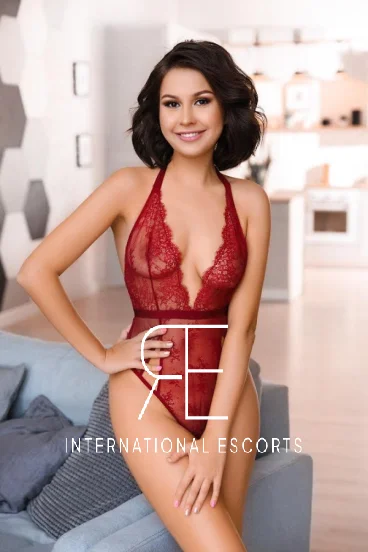 A sexy brunette Russian escort in a red lace body 