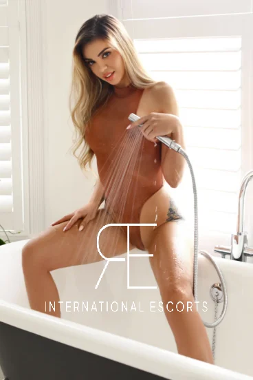 Sexy blonde is spraying herself with water 