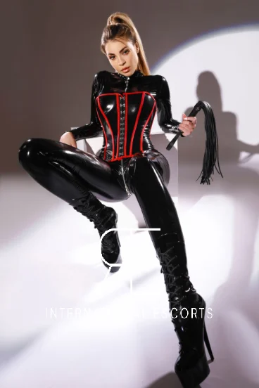 A sexy blonde Mistress is head to toe in black latex 