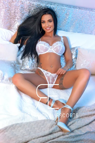 Bishop is sitting on the floor in sexy white lace underwear with her legs wide open