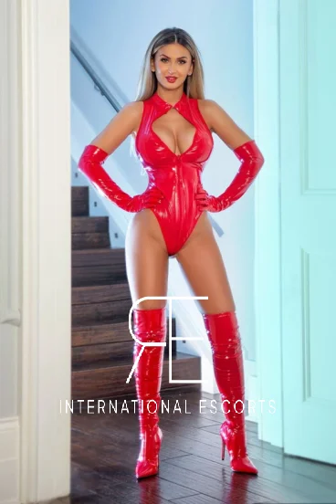 Blonde London escort with big boobs dressed in red PVC