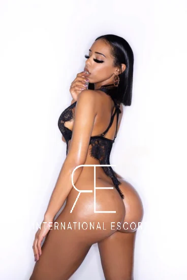 Beautiful ebony escort Cartier is showing off her arse in a black thong 
