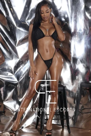 Full length photo of a slim black London escort in a sexy bikini 