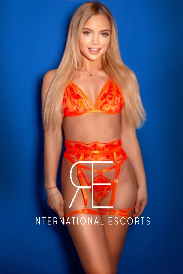 A very sexy blonde escort wearing orange lace lingerie in this picture 