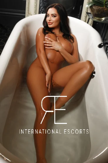 A picture of a very sexy escort laying in her bath 