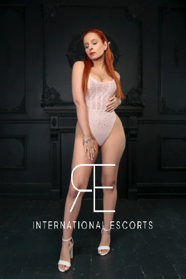 Redhead London escort Arlet wearing white lace underwear 