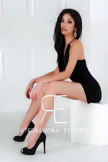 A very sexy Asian named Angelina Grey is wearing a black dress 