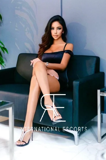 Angelina Grey is wearing a sexy black dress and very sexy high heels 