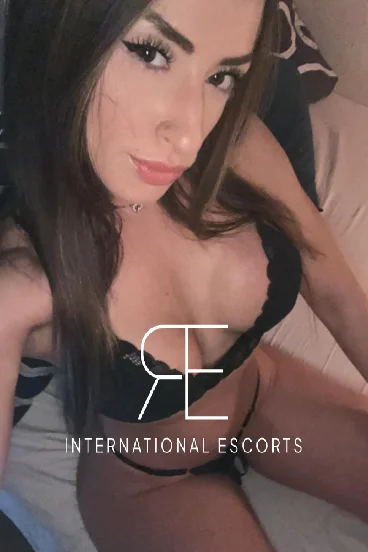 A selfie gallery photo of a sexy Brazilian escort dressed in black lingerie 