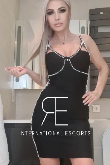 Jolene looks very sexy in a tight fitting back dress 