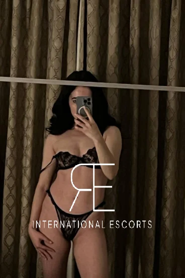 A very sexy brunette London escort taking a mirror selfie 