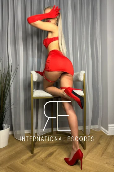 Mistress Choe is bent over a stool and is wearing a tiny red skirt 