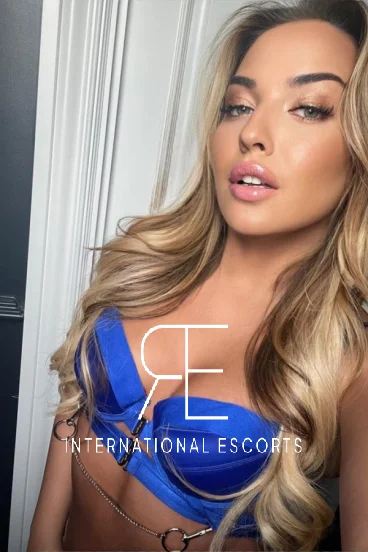 Sexy young London escort Candy is wearing a blue bra 