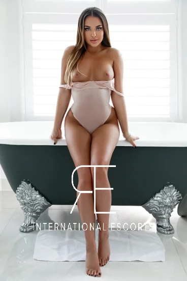 beautiful London escort sitting on the edge of her bathtub 