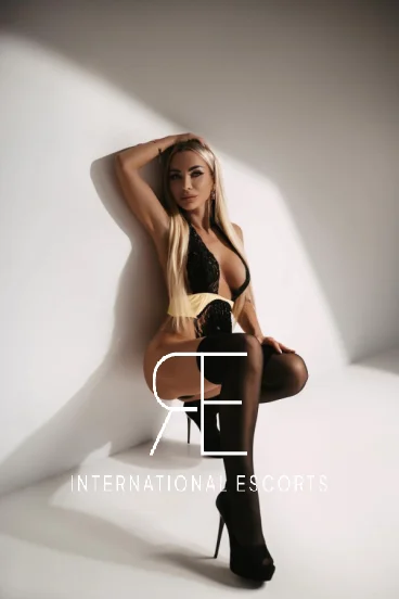 Peaches looks sexy wearing a black lingerie set with black holdup stockings 