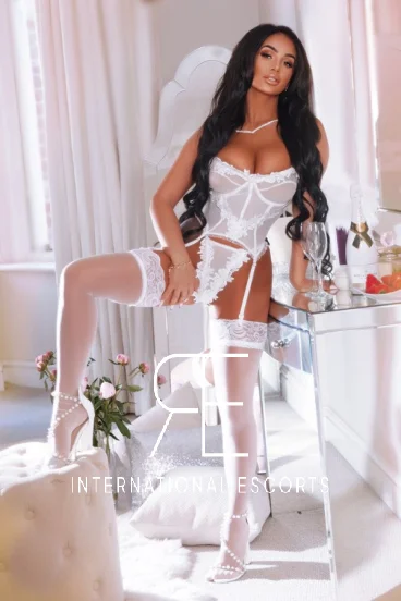 Dressed all in white and wearing white fuck me heels is brunette lady Ernesta 