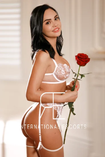 London escort Julie is holding a red rose 