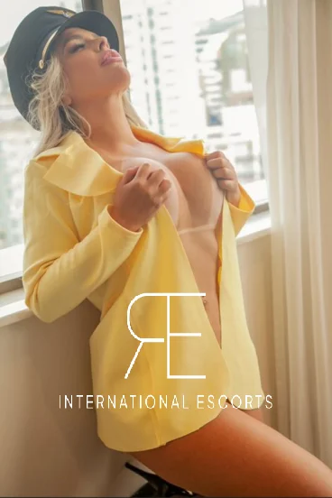 Sexy blonde lady wearing a yellow shirt that is undone 