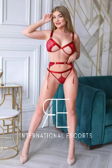 Pictured wearing sexy red lingerie and stilettos is blonde Russian escort Lera 