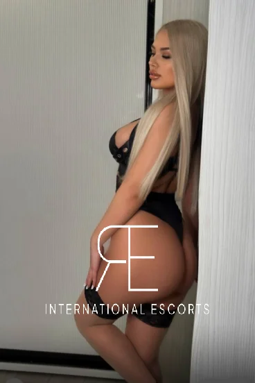 Blonde escort wearing a black basque 