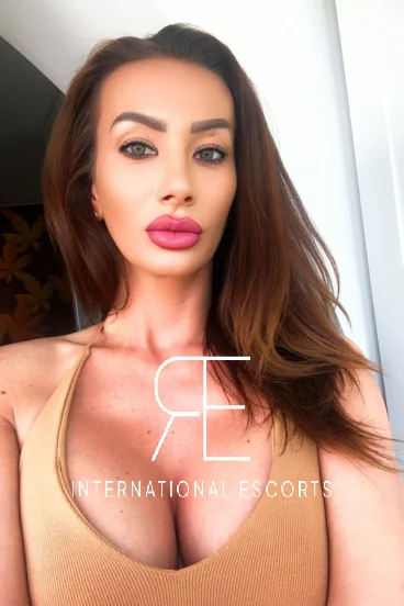 Busty brunette escort with long hair and sexy lips 