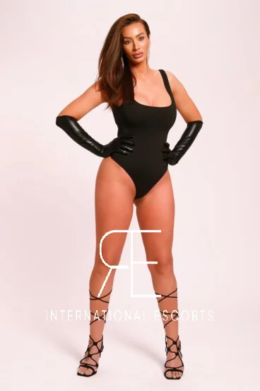 Brunette woman standing with her hands on her hips 