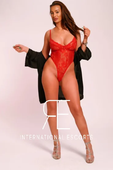 Curvy mature escort Sandra wearing red lace lingerie 