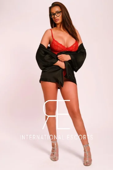 Busty brunette London escort Sandra wearing glasses 