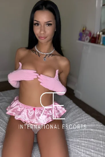 Tarina is covering her boobs with her hands 