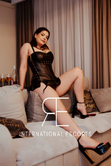 A sexy lady wearing sexy shoes sitting on a sofa 