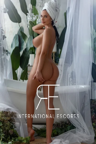 A naked lady with a towel wrapped around her head 