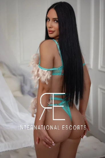 A shapely woman is showing off her very sexy figure dressed in lace lingerie and a thong 