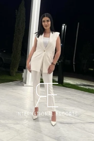 Lady wearing a white trouser suit 
