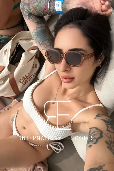 Lady with brunette coloured hair wearing dark sunglasses 