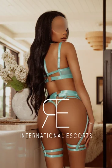Slim sexy black London escort wearing a sexy green thong 