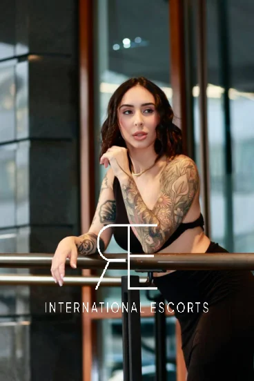 Slim escort lady who has a full sleeve tattoo 