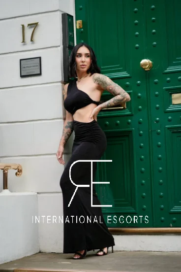 Woman wearing a long cut away black dress 