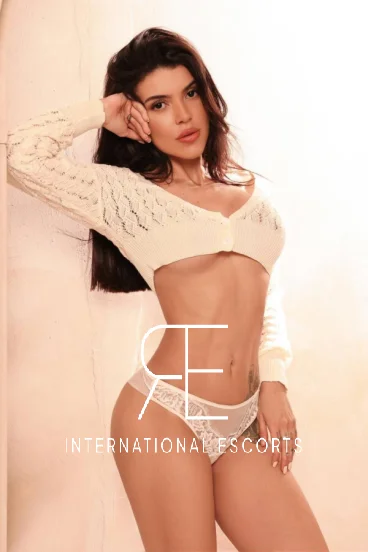 escort in London Aysha wearing a white outfit 