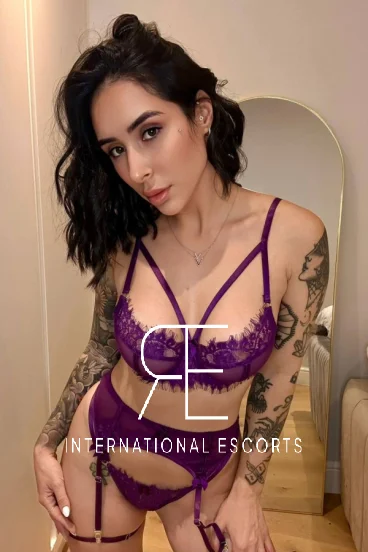 Brazilian escort Nya poses in purple lingerie