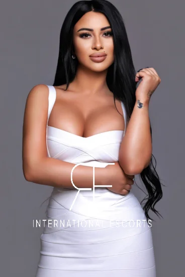 Striking brunette in fitted white bandage dress