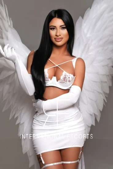 Brunette lady in angel outfit with white lace lingerie