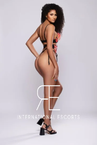 Gigi, ebony beauty in black and red lingerie looking back