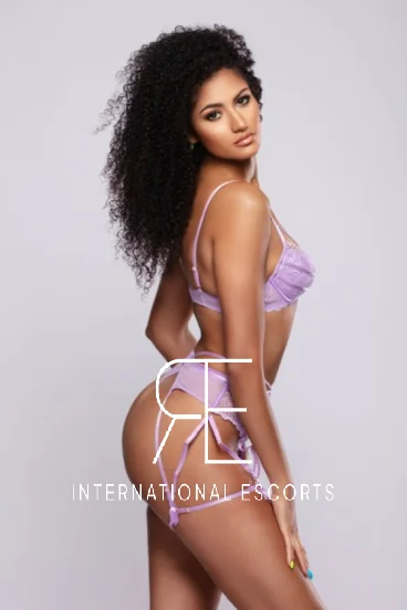 Glamorous ebony model Gigi in lilac lingerie posing with curves