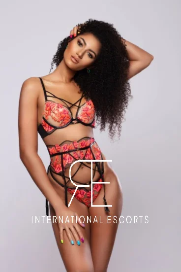 Ebony London escort Gigi in floral lingerie with confident stance