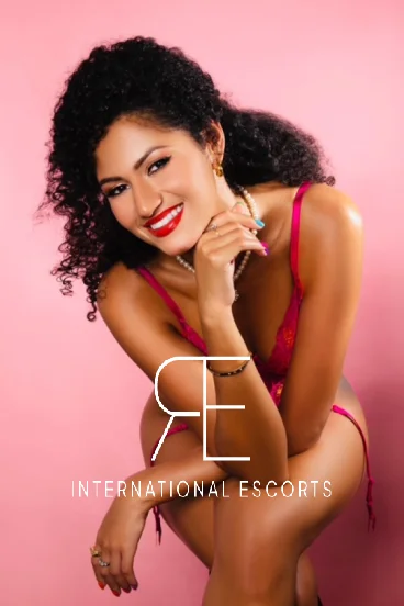 Sensual ebony escort Gigi in red lingerie with jewellery