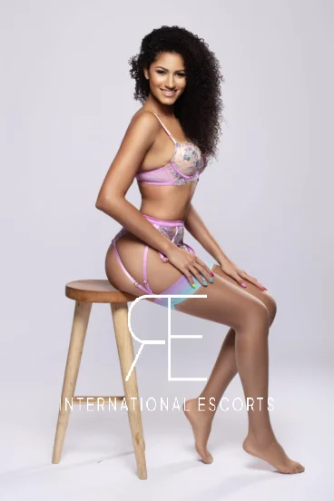 Gigi, stunning ebony beauty in pastel lingerie perched on stool