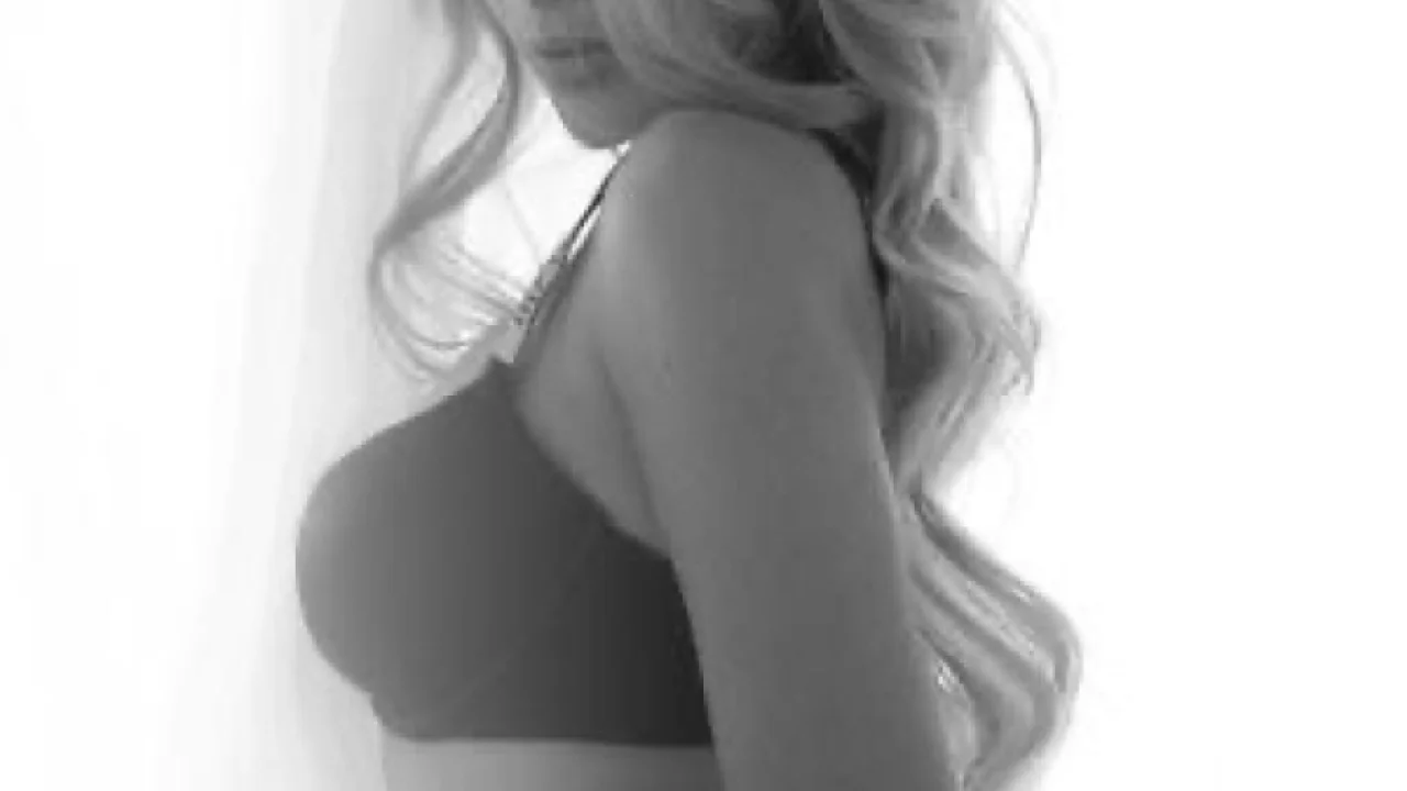 Cosmopolitan Brazilian escort Mara in lingerie, hotel window London view