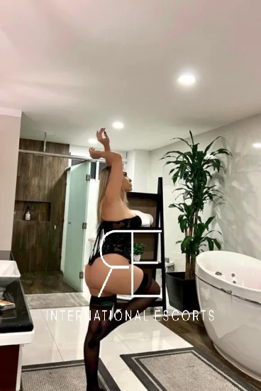 Brazilian escort Mara in corset lingerie, luxury bathroom international style