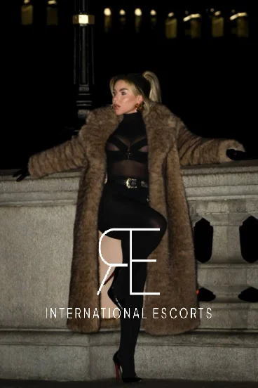 Lainey exudes allure in chic fur coat and sheer black outfit
