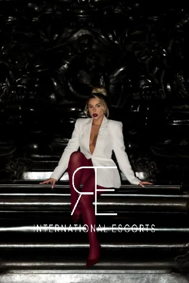 Lainey posing with elegance in blazer and red tights